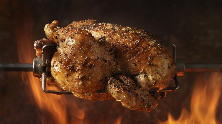 Rotisserie chicken over flames