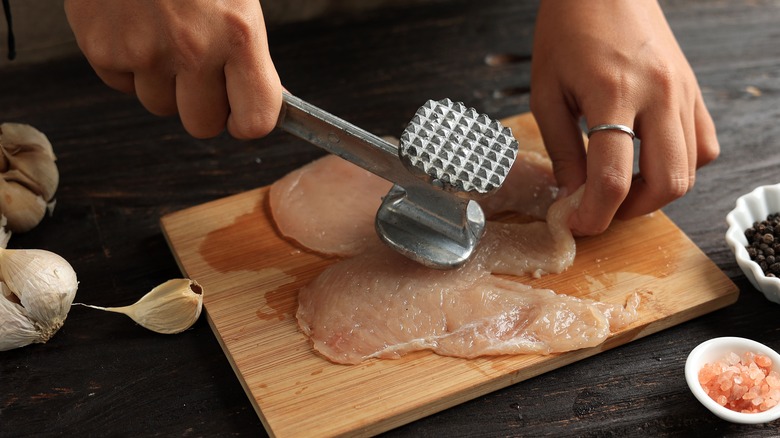 using meat mallet on chicken