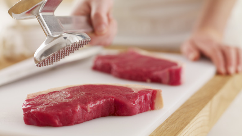 Meat mallet tenderizing steaks