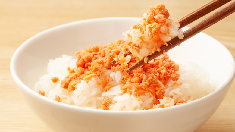 salmon and rice with chopsticks