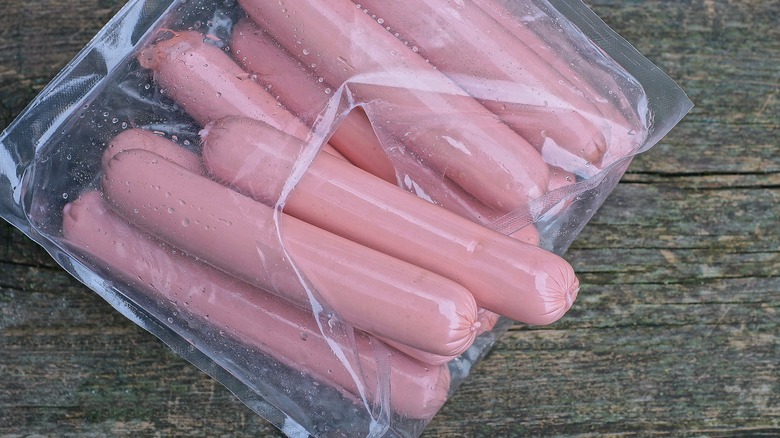 Torn package of hot dogs