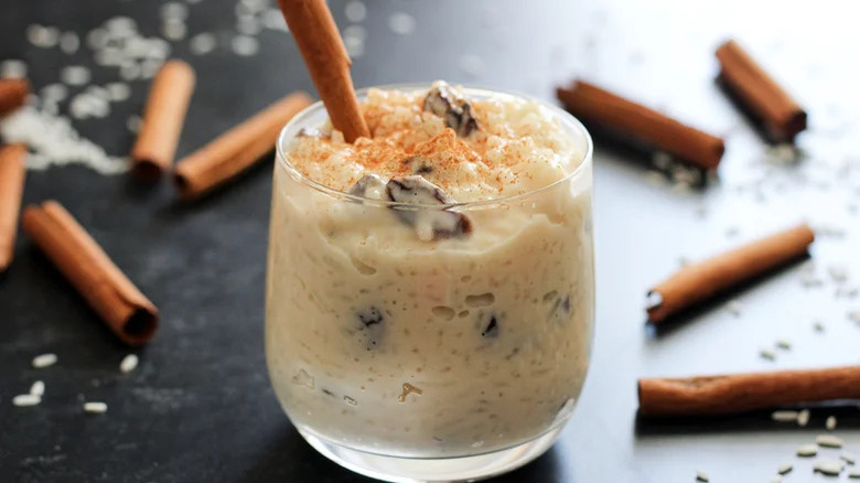 Arroz con leche in glass with cinnamon on surface