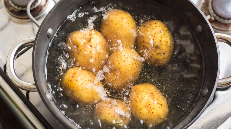 a pot of potatoes boiling in water