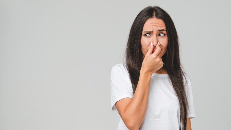 young woman pinching nose