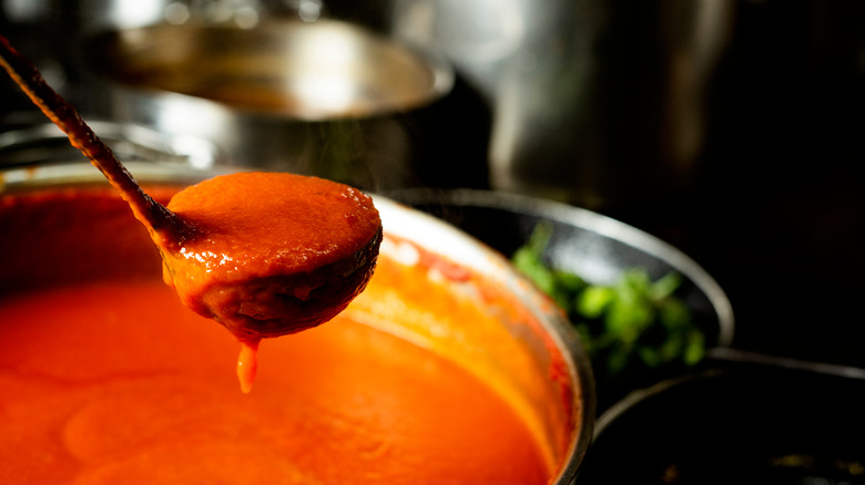 A ladle of red sauce