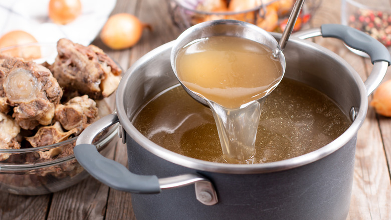 Bone broth in pot with ladle