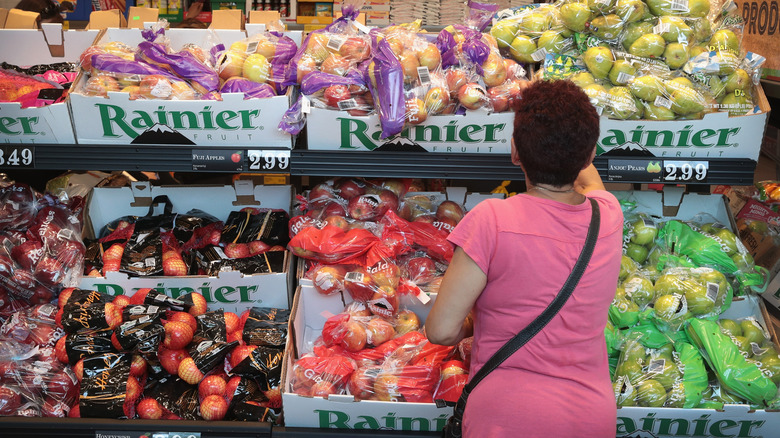 Woman whopping for fruit at Aldi store