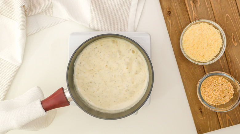 alfredo sauce in pan white table