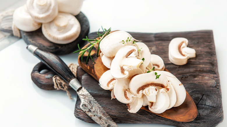 Fresh, sliced mushrooms on board