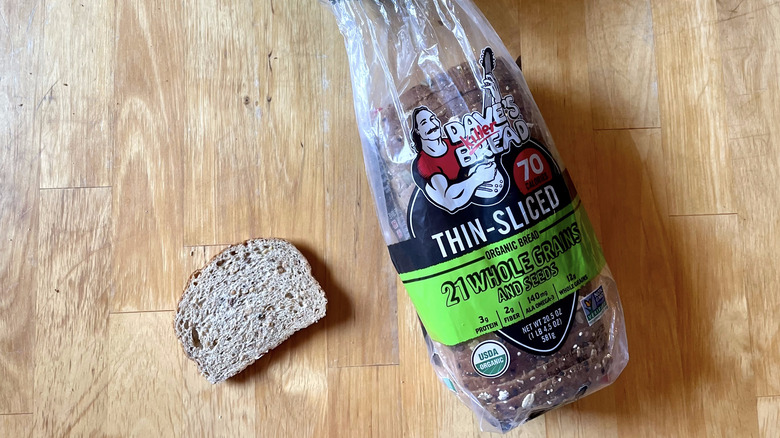 slice of bread next to 21 Whole Grains and Seeds loaf