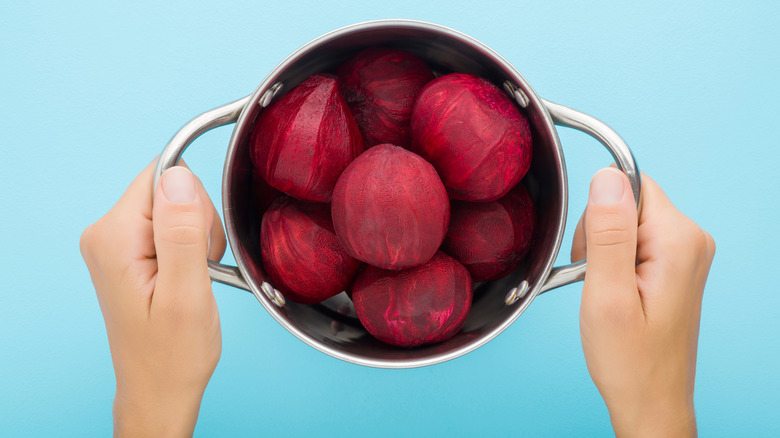 hands holding boiled beets