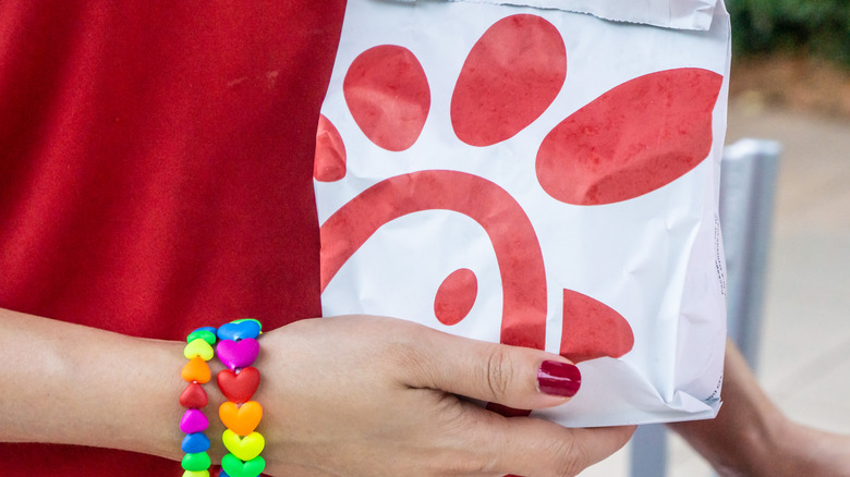 Hand holding Chick-fil-A bag