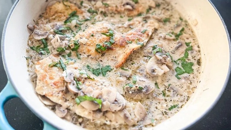 Chicken marsala with herb garnish