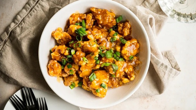 Plated orange chicken with scallions