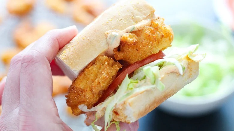 Person holding po' boy sandwich