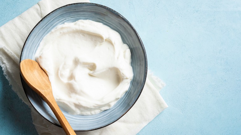 Cream cheese with wooden spoon