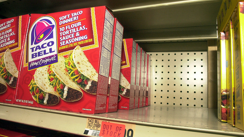 Image showing boxes of Taco Bell Soft Taco Dinners, next to empty space that should contain Taco Bell's hard-shelled tacos, during the StarLink corn recall in 2000