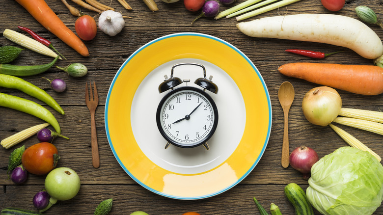 clock surrounded by vegetables 