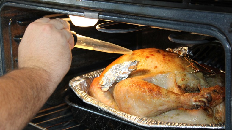 basting turkey in the oven