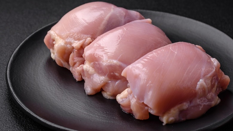 three raw chicken thighs