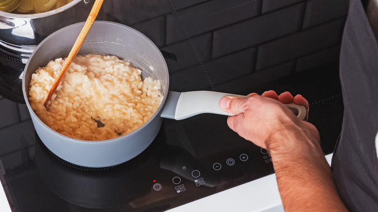 Stirring risotto in saucepan 