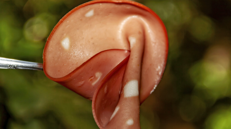 sliced mortadella on fork