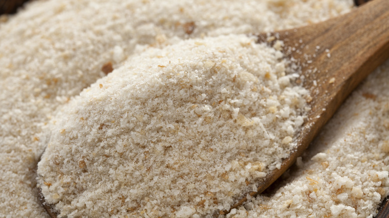 Wooden spoon filled with breadcrumbs