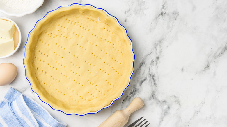 unbaked pricked pie crust in dish