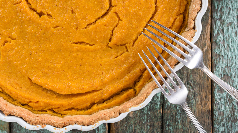 cracked pumpkin pie with forks