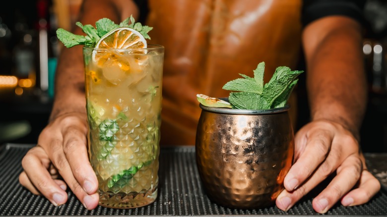 bartender holding two cocktails