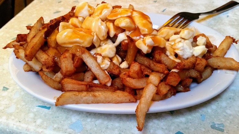 poutine on plate with fork