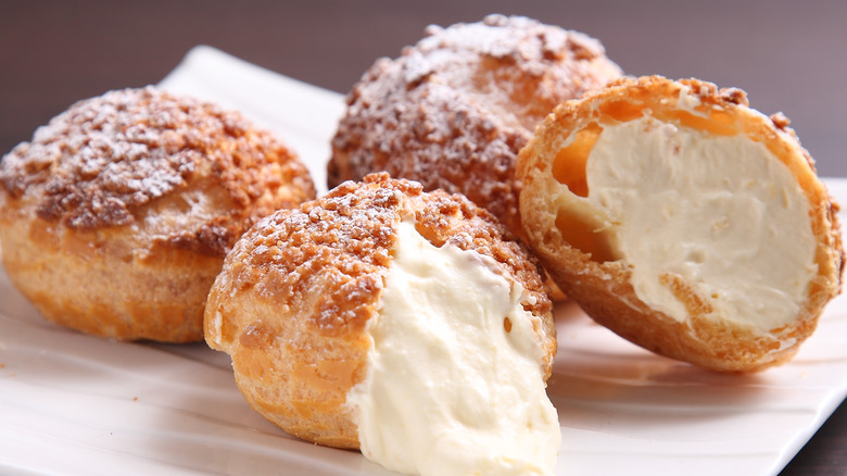 Cut cream puffs on plate