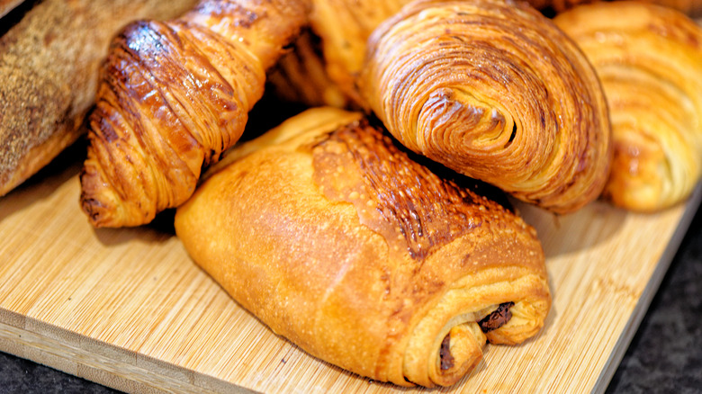 Croissants piled on cutting board