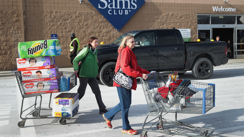 Women pushing carts through Sam's Club parking lot