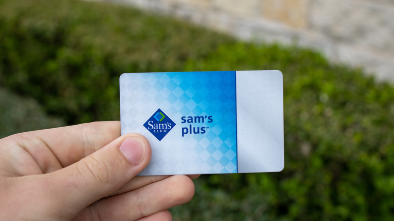 Hand holding a Sam's Club Plus membership card