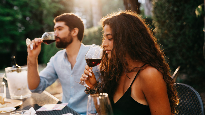 two people drinking wine