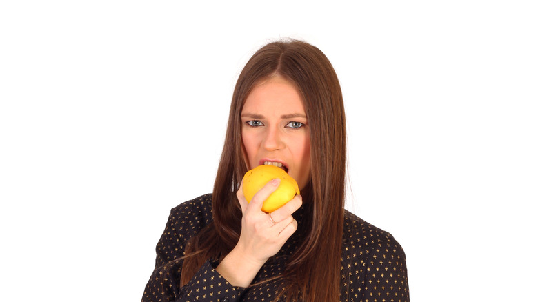 woman biting quince