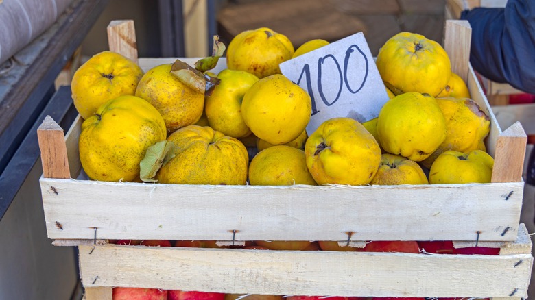 crate of quinces and apples