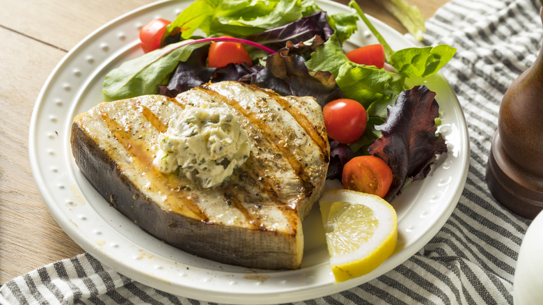 Grilled swordfish steak on plate 