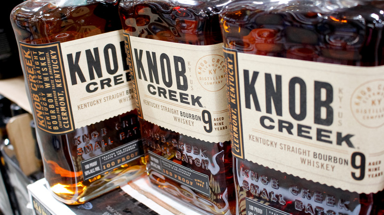 shelf of Knob Creek bourbon bottles