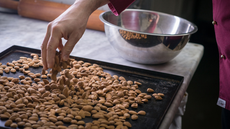 almonds spread on baking sheet