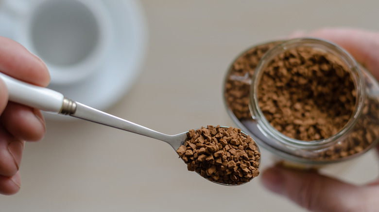 Instant coffee granules on spoon