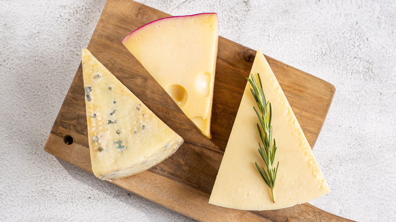 Cheese wedges on cutting board