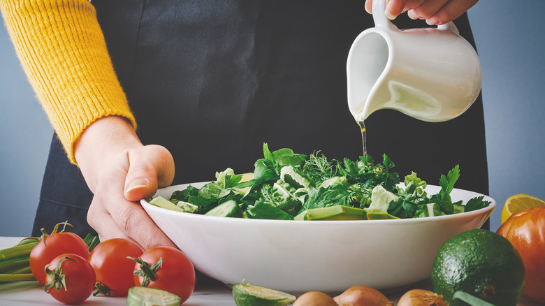 Drizzling salad with dressing