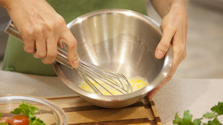 Whisking homemade salad dressing