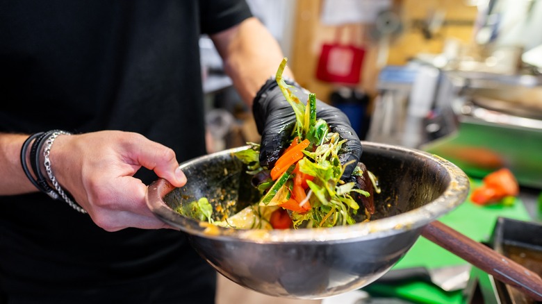 Tossing a salad by hand