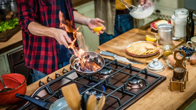 man flambéing food