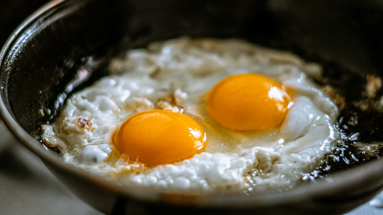 two fried eggs in a pan