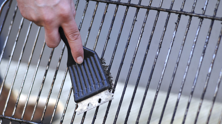 Grill being cleaned with spatula