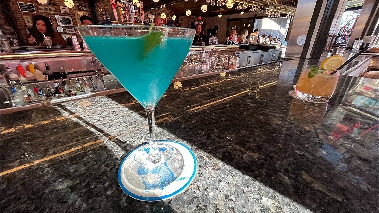 Blue martini with basil garnish